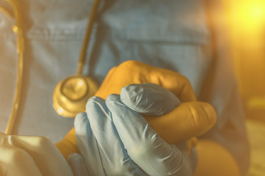 Doctor's gloved hand comforting cancer patient, cancer gene DNA research, cancer early detection