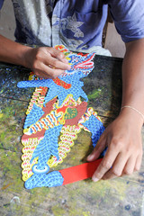 Man during the manufacture of a Wayang kulit or Shadow puppets