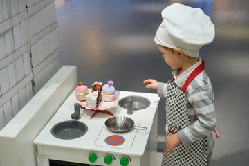 Сhild playing chef in the store