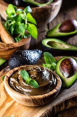 Avocado chocolate mousse with mint in olive wooden bowl © lblinova