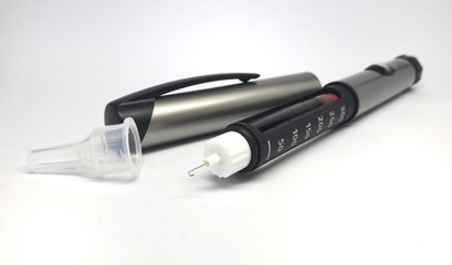 Insulin pen with needle on white background