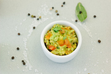 Traditional mexican avocado - vegetarian dip surrounded by its ingredients.