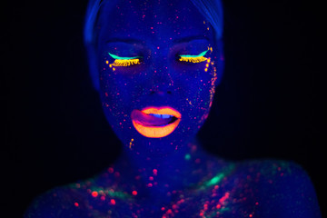 Portrait of Beautiful Fashion Woman in Neon UF Light. Model Girl with Fluorescent Creative Psychedelic MakeUp, Art Design of Female Disco Dancer Model in UV, Colorful Abstract Make-Up