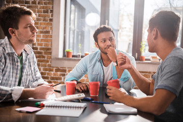 Group of young professionals working on business project together