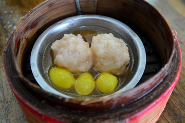 Chinese pork dumplings in a bamboo steamer