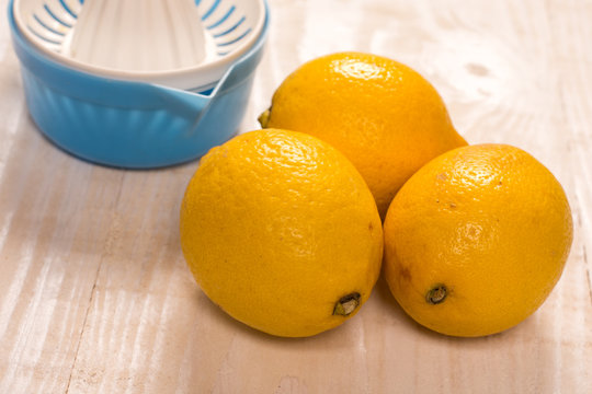 Fresh yellow lemons with plastic strainer