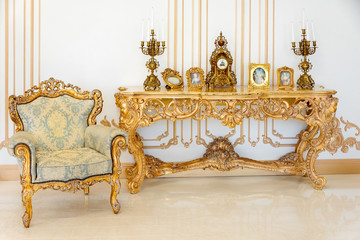 Luxury livingroom in light colors with golden furniture details. Elegant classic interior
