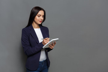 Business woman checking schedule in notepad