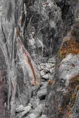 River canyon enclosed by weathered grey granite cliffs