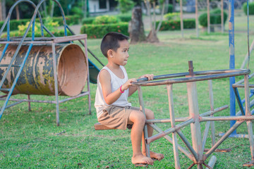 Boy with exercise machines in the park