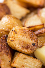 Macro closeup fried young potatoes with blurred background