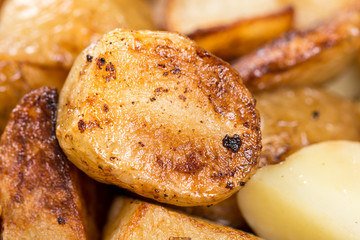 Macro closeup fried young potatoes with blurred background