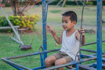 Boy with exercise machines in the park