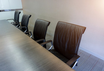 Empty corporate chair in conference room before business meeting.