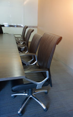 Empty corporate chair in conference room before business meeting.