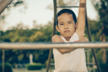 Fototapeta premium Boy with exercise machines in the park