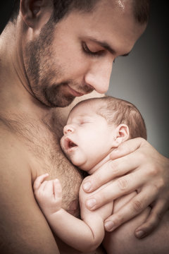 newborn child and father