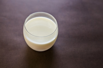 glass of milk on wooden background