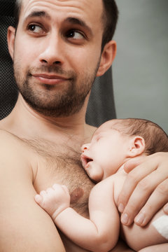 newborn child and father
