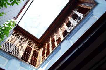 Bottom view of blue terrace with wooden windows, architecture concept
