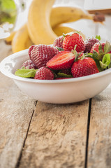 strawberry banana fruits on wood table