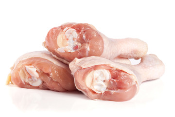 Three raw chicken drumsticks isolated on white background