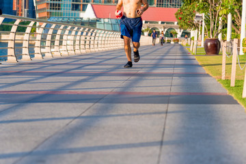 Healthy man running exercise in the morning in Marina Bay Sand park, Singapore.