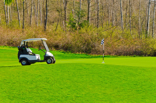 Golf cart over green and bunker.