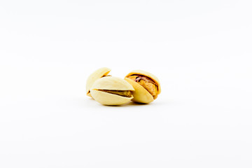 Isolated roasted pistachios nuts on a white background