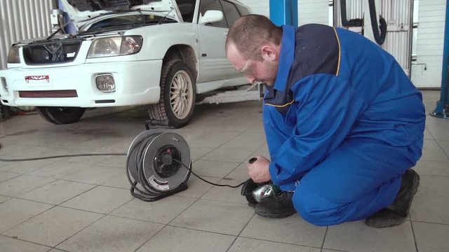 car mechanic work with circular saw cutting metal with sparks in super slow motion 120 fps