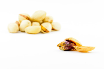 Isolated roasted pistachios nuts on a white background