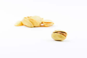 Isolated roasted pistachios nuts on a white background