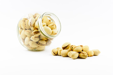 Isolated roasted pistachios nuts on a white background