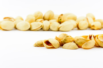 Isolated roasted pistachios nuts on a white background