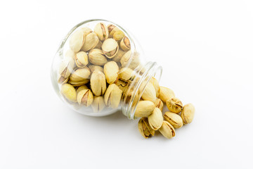 Isolated roasted pistachios nuts on a white background