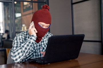 electronic crime concept. hacker is calling while using computer.