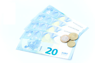 Close-up of Euro money - 20 euro banknotes and euro coin on white background.
