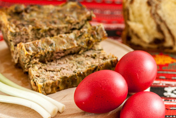     traditional romanian easter dishes colored eggs sponge cake and meat cake 