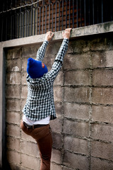 intrusion concept. burglar is climbing wall.