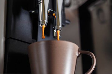 Close-up of espresso pouring from coffee machine 