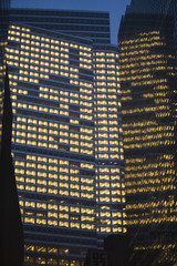 Fototapeta na wymiar Skyscrapers windows at nigth.