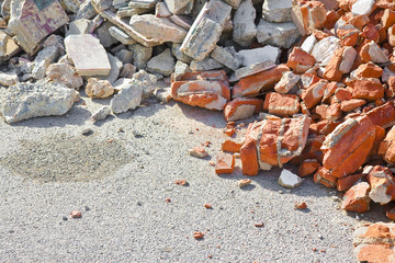 Concrete and brick rubble debris on construction site after a demolition of a brick building