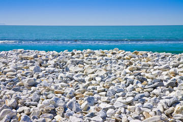 White and gray stones softly rounded against a blue sky