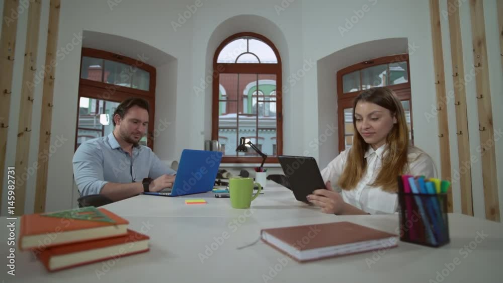 Aufkleber partners working together in the office. co workers sitting at the desk indoors. caucasian employees