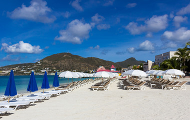 Fototapeta na wymiar beach chairs and white umbrellas on caribbean island
