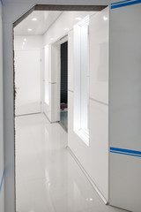 Modern home hallway interior. White plactic panels and tiles. Futuristic interior concept design. Space ship at home.