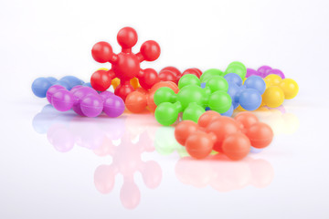 Colorful meccano plastic toys on a white surface. Meccanos isolated on white background.