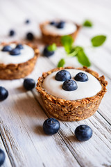 Nutritious granola cups filled with yoghurt and blueberry