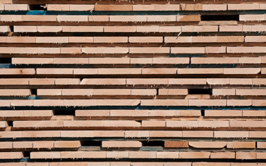 The ends of boards stacked in a lumberyard