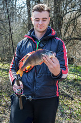 a fisherman caught a big bass on spinning . blurred background